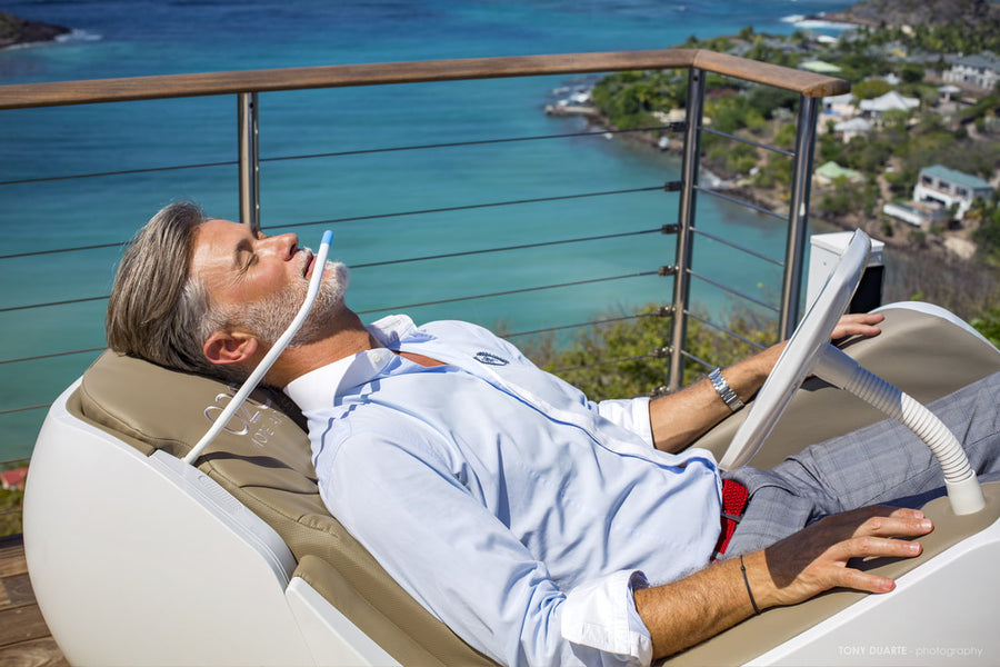 A user reclining in O2Chair during a guided breathing session